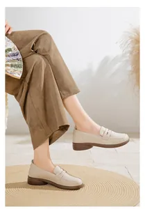 Close-up of stylish beige flat loafers for women showing the soft texture and stitch detail