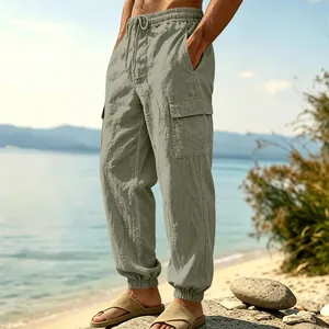 Close-up of men's linen cargo pants in sage green with elastic waist and pockets