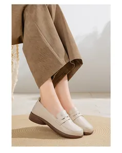 Comfortable beige leather loafers for women featuring soft soles and a minimalist design