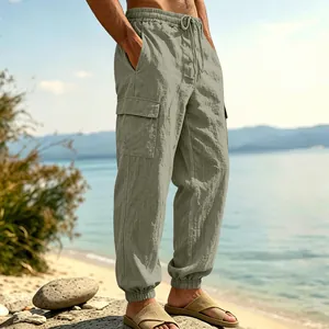 Side view of olive green linen cargo pants featuring large side pockets and drawstring waist.