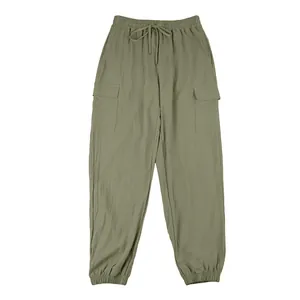 Full silhouette of olive green cargo pants with drawstring waist and jogger cuffs