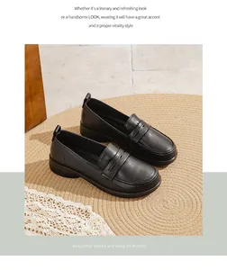 Detailed view of comfortable black soft leather loafers on a rustic woven mat