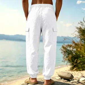 Rear view of white linen cargo joggers for men showing the fit and pocket details at beach