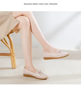 Detailed side view of breathable pink leather flat loafers with bow decoration for women