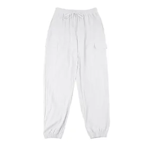 Full view of white linen cargo pants with drawstring waist and multi-pocket design