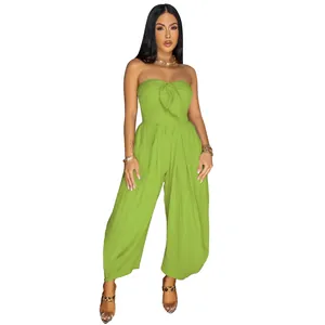 Detail view of a sexy strapless lime green jumpsuit with front tie knot detail