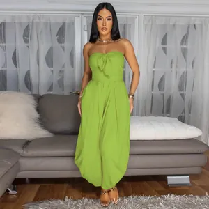 Sexy lime green strapless jumpsuit with bow detail in a living room setting