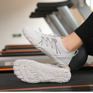Close-up view of white quick-dry aqua shoes showing textured grip sole on a treadmill