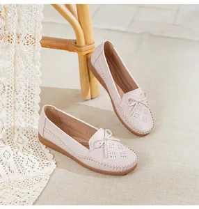 Detailed view of breathable women's loafers with floral laser-cut patterns and bow