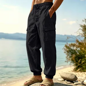 Detailed side view of men's black linen cargo pants with multi-pockets and jogger cuffs.