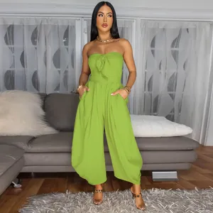 Elegant front view of a sexy lime green strapless jumpsuit with bow detail and pockets.