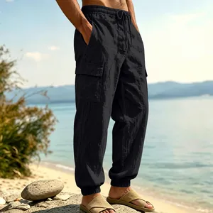Side view detail of men's black linen cargo pants with large pockets and cuffed hems