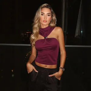 Sexy maroon halter top with metal buckle detail shown on model in night city setting