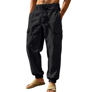 Detail view of black linen cargo pants for men with pockets and drawstring waist