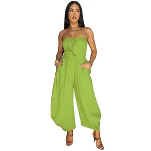 Macro view of the textured lime green fabric and front knot detail on this strapless jumpsuit