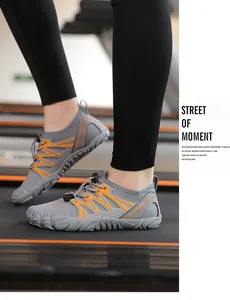 Side view detail of grey and orange quick-dry water shoes on a gym treadmill