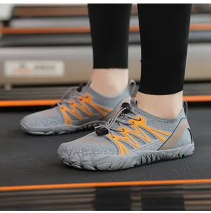 Grey and orange quick-dry outdoor water shoes for hiking and wading shown on a treadmill