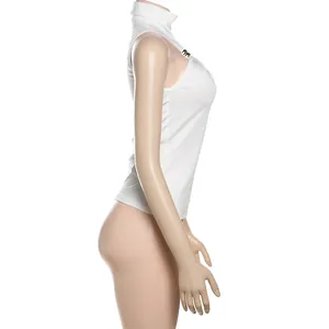 Side detail view of white sleeveless mock neck top with elegant metallic buckle decoration