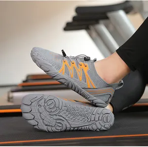 Detailed view of grey and orange quick-dry water shoes with non-slip sole on a treadmill