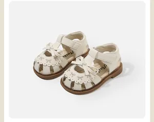 Elegant cream toddler girl sandals with bow decoration and scalloped caged toe design