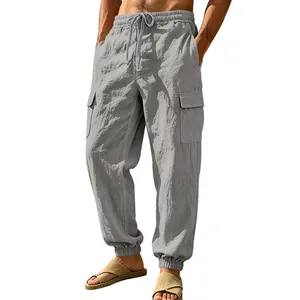 Detail of loose men's linen cargo joggers with pockets and drawstring waist