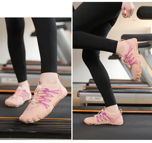Pink quick-dry aqua shoes for swimming and outdoor sports shown on a treadmill