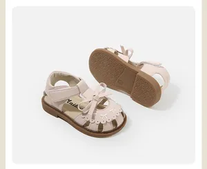 Detail view of pink toddler girl's princess sandals with cute bow and embroidery