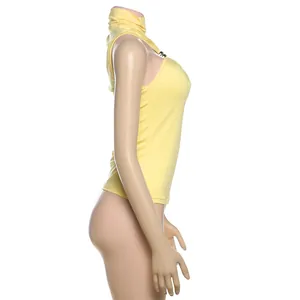 Side view of a vibrant yellow halter neck tank top with a stylish metal ornament.