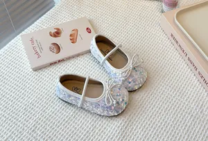 Close-up view of sparkling sequined Mary Jane shoes for girls with elegant bow detail