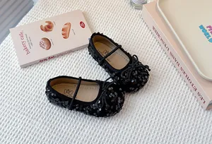 Close-up of elegant black sequined Mary Jane shoes for girls featuring a dainty bow detail