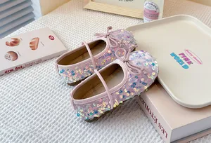 Sparkly pink sequined girls princess flats with bow detail on soft white texture