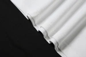 Macro view of professional double-stitched hem on white cotton sleeveless vest top