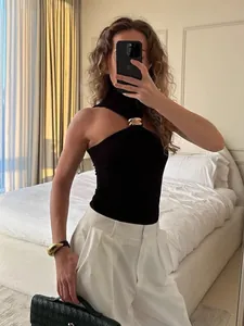 Stylish black halter neck sleeveless top with elegant gold metal ring detail for women
