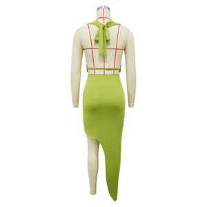 Back view of lime green halter top and asymmetrical high slit skirt set on mannequin