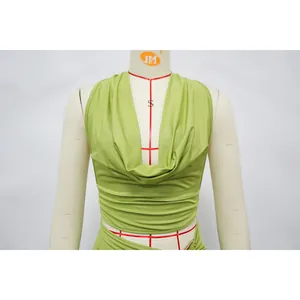 Close-up detail of a vibrant green cowl neck halter top with elegant gathered fabric