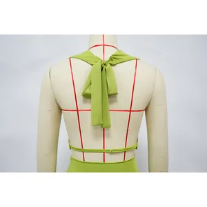 Back view detail of a lime green halter neck top featuring a tie-knot design on mannequin