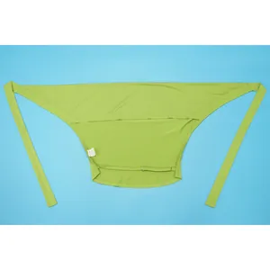 Flat lay detail of a lime green halter top with wrap ties on a blue background