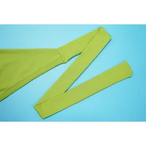 Close-up detail of lime green halter strap and ribbed fabric texture of skirt set