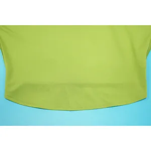 Close-up detail of the smooth stitching and lime green fabric texture of the skirt set