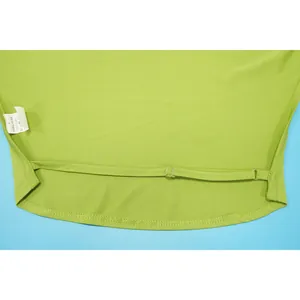 Detail view of neon green fabric stitching and material care label with size S