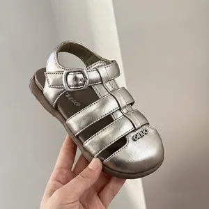 Detail showing a silver metallic baby girl sandal with closed-toe design and soft sole