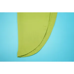 Detailed close-up showing the professional stitching and smooth green fabric on the skirt hem