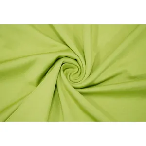 Close-up macro view of lime green ribbed knit fabric texture and elegant swirl drape