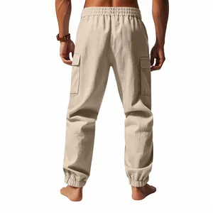 Detail view of men's beige linen cargo joggers from behind on white background