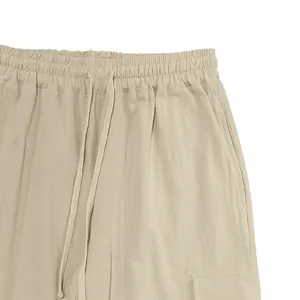 Close-up detail of men's linen cargo pants featuring a drawstring elastic waistband