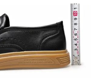 Close-up detail of black leather loafer heel height being measured by a vertical ruler.
