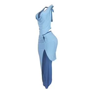 Side view of light blue two-piece set featuring halter neck cowl top and high slit skirt