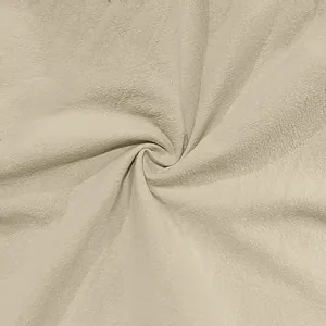 Close-up macro view of natural beige linen fabric texture for men's pants