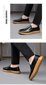 Detailed side view of black men's leather loafers featuring a durable gum rubber sole