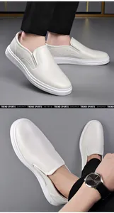 Close-up detail of white leather business loafers for men with sleek slip-on design.